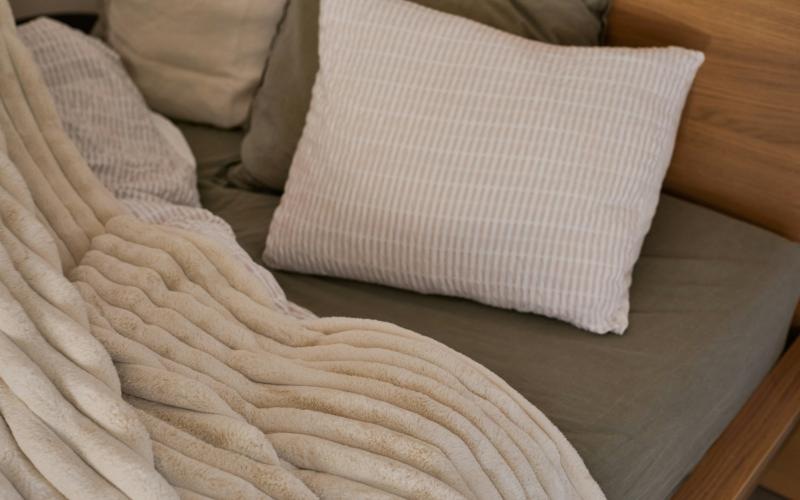 a white pillow on a bed