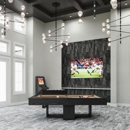 a lounge with a tv, pool table and chairs